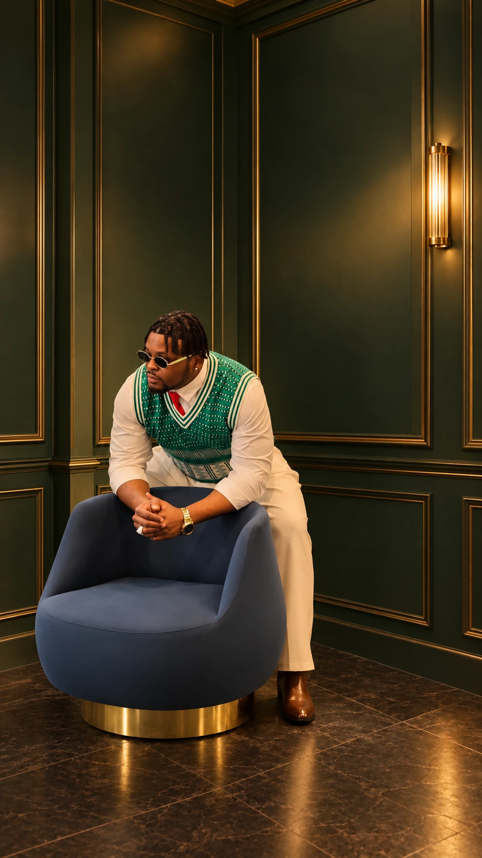 King Pwest in a green patterned vest and cream outfit